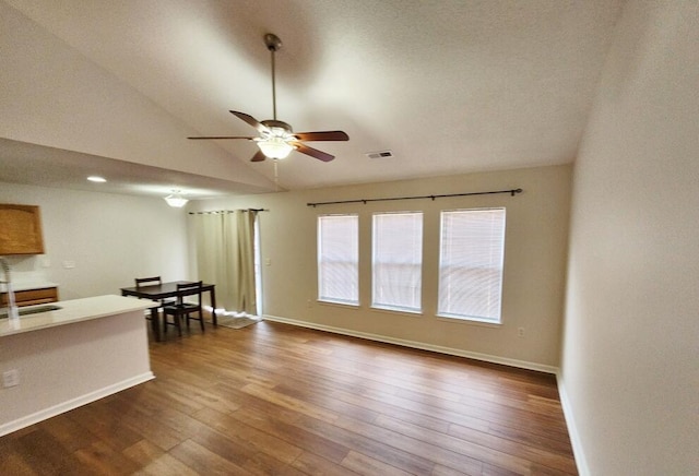 living room featuring dark hardwood / wood-style floors, ceiling fan, lofted ceiling, and sink