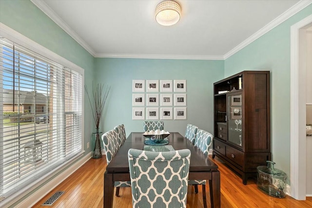 dining room featuring crown molding and hardwood / wood-style flooring