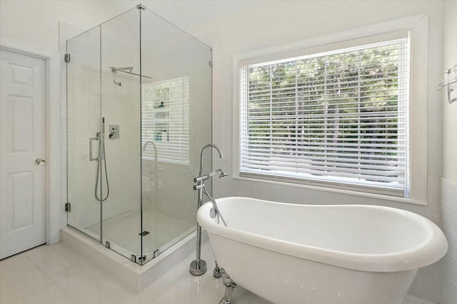 bathroom featuring tile patterned flooring and independent shower and bath