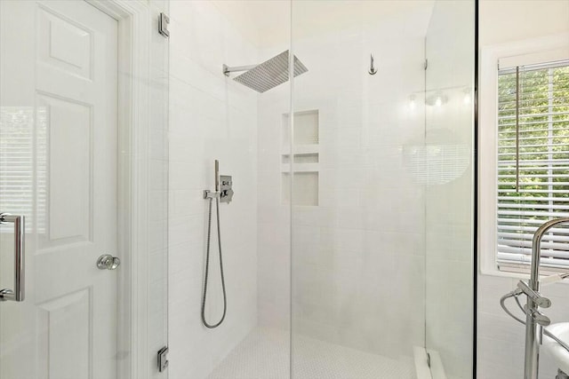 bathroom with a shower with door