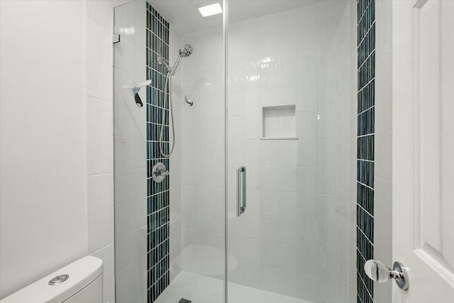 bathroom with toilet and an enclosed shower