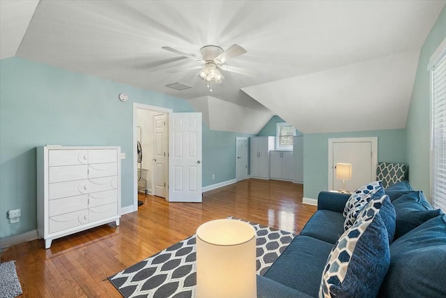 living room with ceiling fan, hardwood / wood-style floors, and vaulted ceiling