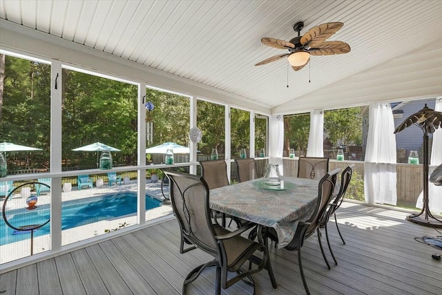 sunroom featuring ceiling fan and lofted ceiling