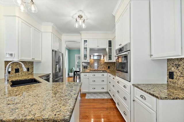 kitchen featuring white cabinets, appliances with stainless steel finishes, and sink