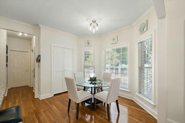 dining area with wood-type flooring and a notable chandelier