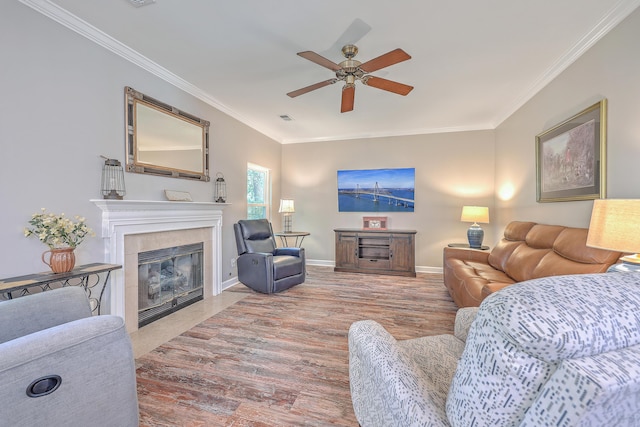 living room with ceiling fan and ornamental molding