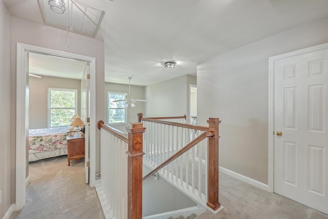 hallway featuring light colored carpet