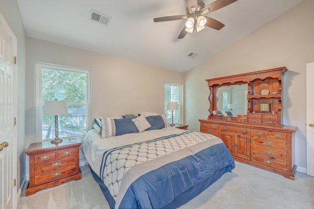 carpeted bedroom featuring multiple windows, lofted ceiling, and ceiling fan