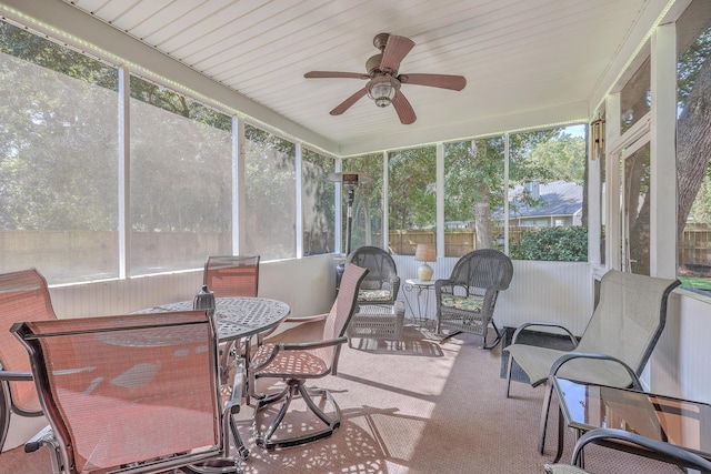 sunroom with ceiling fan and plenty of natural light