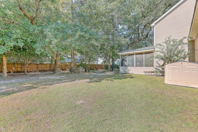 view of yard with a shed and a sunroom