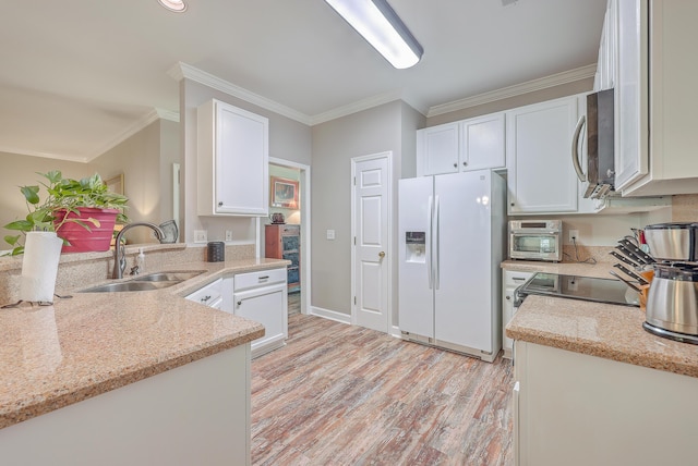 kitchen featuring white fridge with ice dispenser, sink, white cabinets, and light stone counters