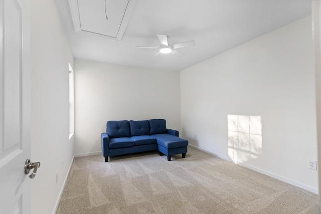 living area with ceiling fan and light colored carpet