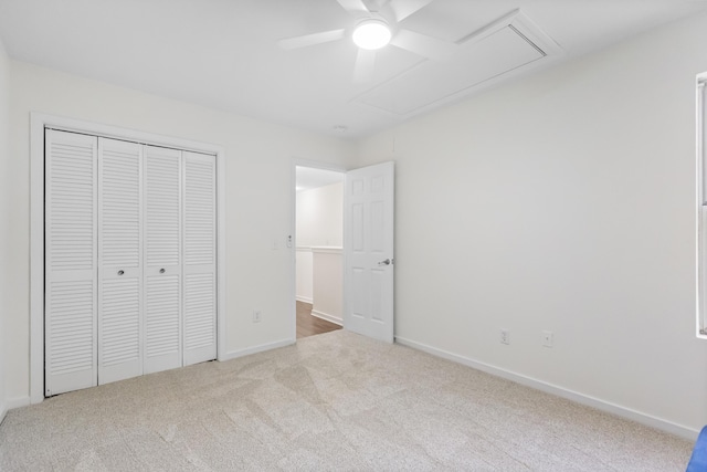 unfurnished bedroom featuring light carpet, a closet, and ceiling fan