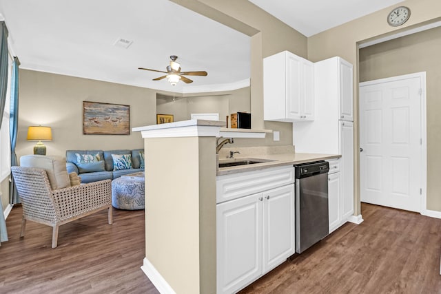 kitchen with kitchen peninsula, dishwasher, sink, and hardwood / wood-style floors