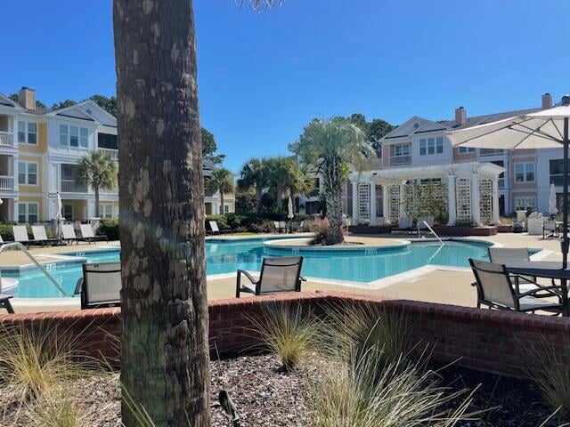 view of swimming pool featuring a patio and a pergola