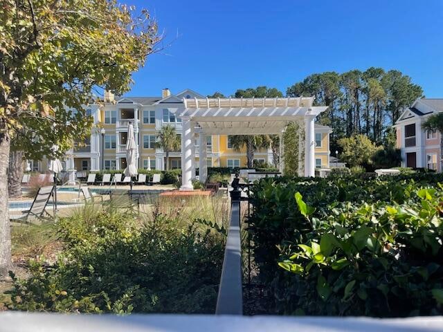 surrounding community featuring a pool and a pergola