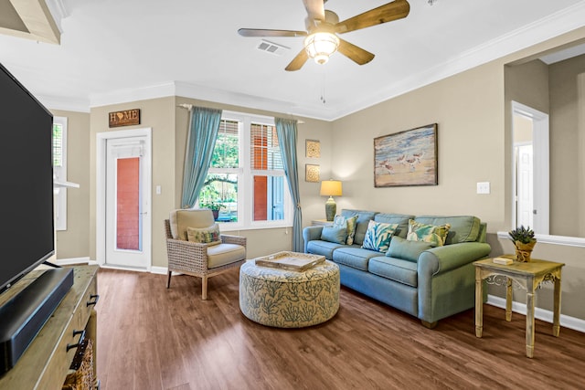 living room with dark wood-type flooring, ceiling fan, and ornamental molding