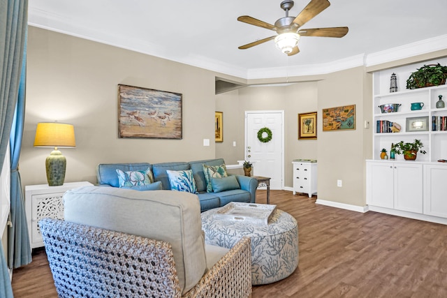 living room with ceiling fan, ornamental molding, and dark hardwood / wood-style floors