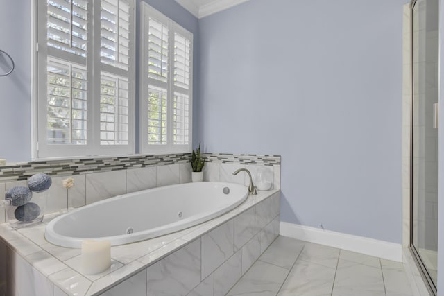 bathroom with separate shower and tub and ornamental molding