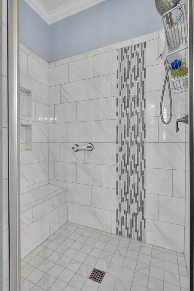 bathroom featuring crown molding and tiled shower