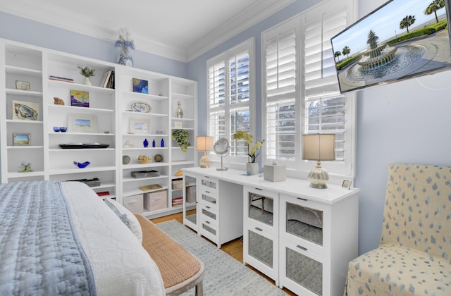 bedroom featuring ornamental molding and wood-type flooring