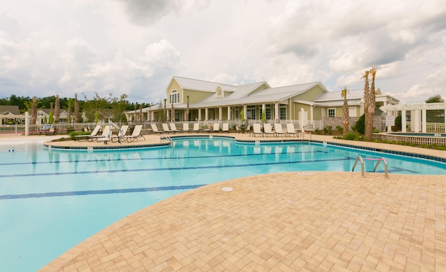 view of swimming pool with a patio and a pergola