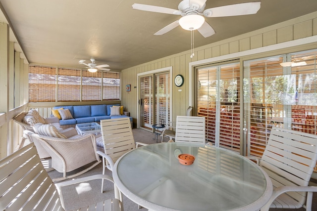 carpeted dining room with ceiling fan