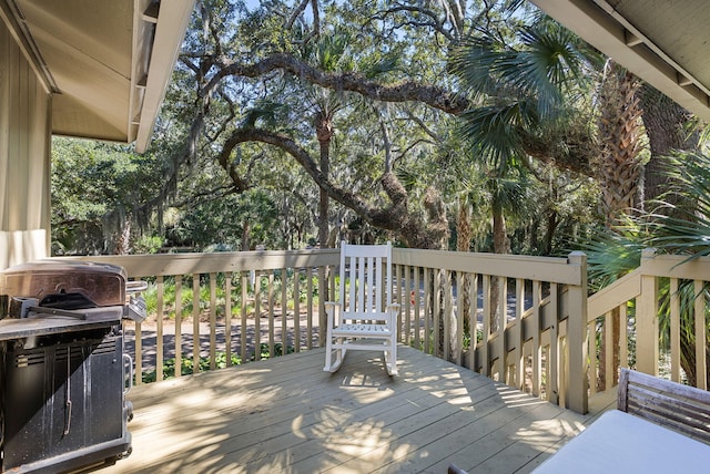 wooden terrace with a grill
