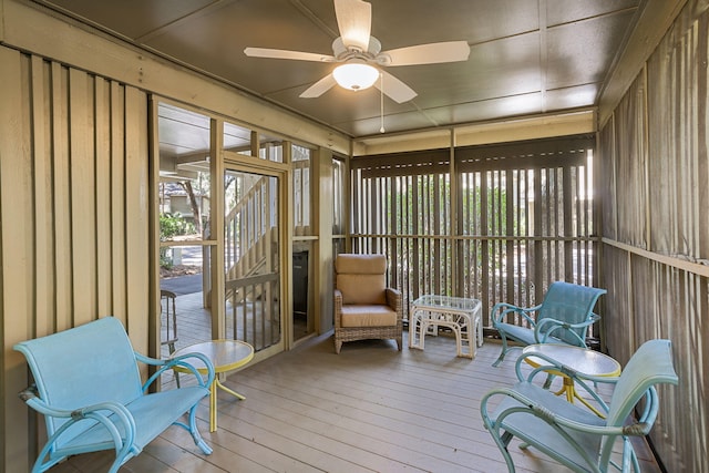 sunroom featuring a ceiling fan