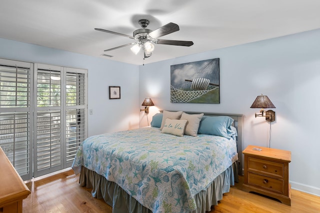 bedroom with light wood finished floors, access to outside, and ceiling fan
