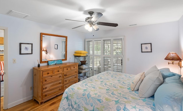 bedroom featuring light wood-type flooring, baseboards, and a ceiling fan