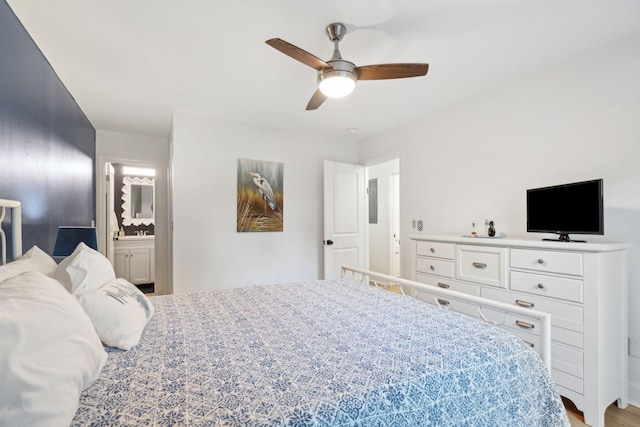 bedroom featuring connected bathroom, light hardwood / wood-style floors, and ceiling fan