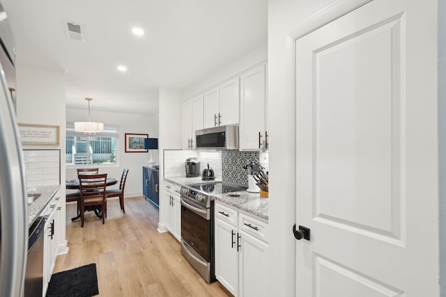 kitchen featuring light hardwood / wood-style floors, white cabinetry, and appliances with stainless steel finishes