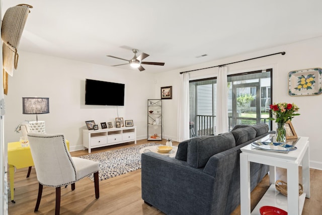 living room with ceiling fan and light hardwood / wood-style floors