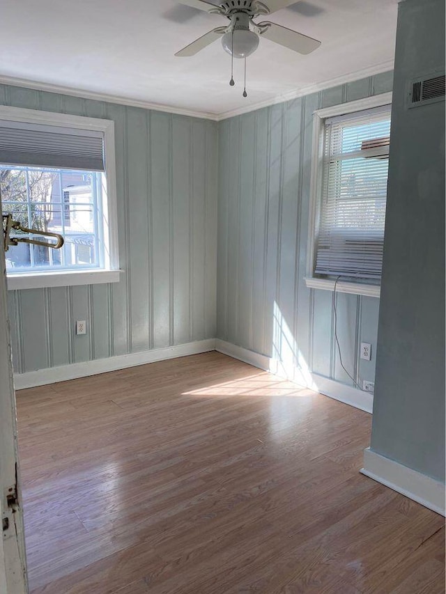 spare room with wood-type flooring and ceiling fan