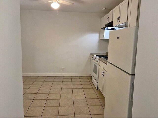 kitchen with ceiling fan, sink, light tile patterned floors, white appliances, and white cabinets