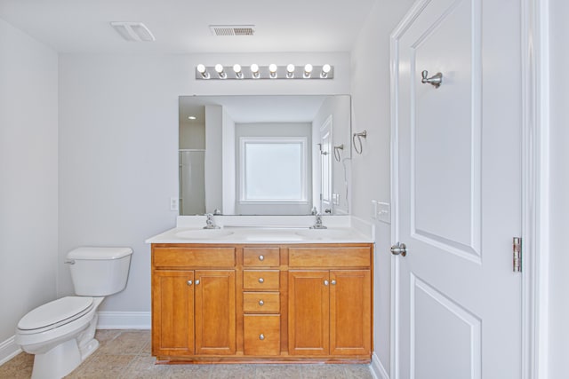 bathroom with visible vents, a sink, toilet, and double vanity