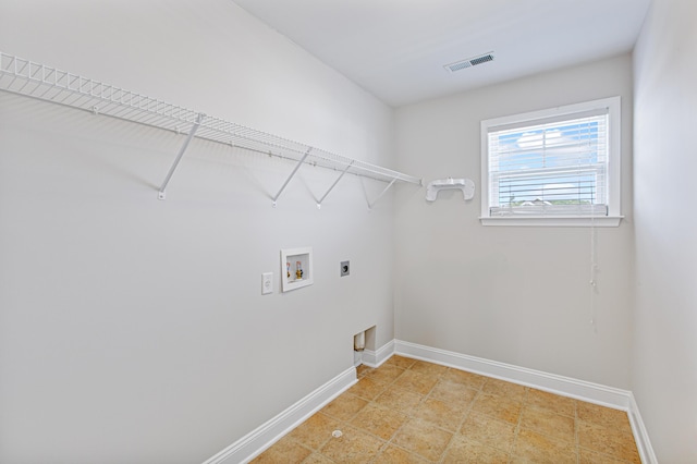 clothes washing area with washer hookup, visible vents, electric dryer hookup, laundry area, and baseboards