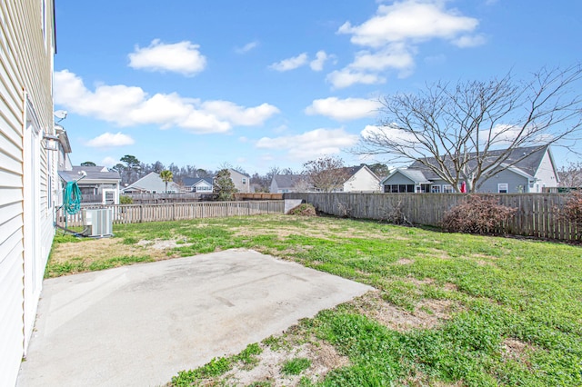 view of yard featuring central AC, a patio area, a residential view, and a fenced backyard