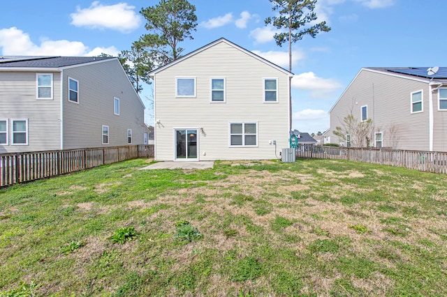 rear view of property featuring cooling unit, a patio area, a fenced backyard, and a lawn