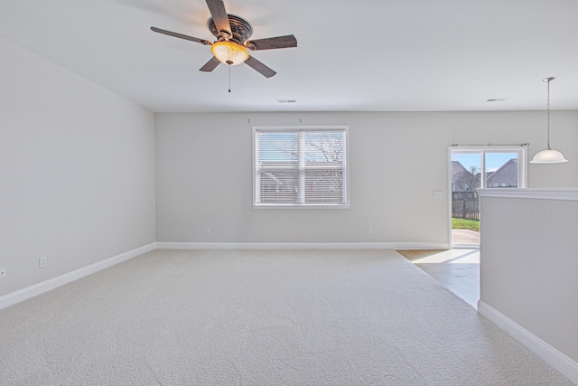 unfurnished room with light carpet, plenty of natural light, and baseboards