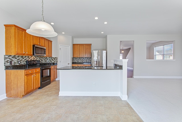 kitchen with baseboards, stainless steel appliances, backsplash, and brown cabinets