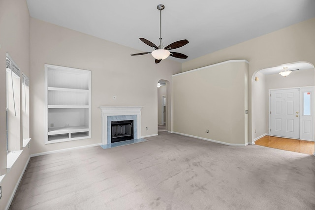 1445 Ashley Gardens Blvd, Charleston, SC 29414 - unfurnished living room with ceiling fan, arched walkways, built in shelves, carpet, and baseboards