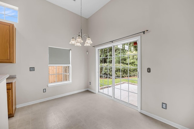 1445 Ashley Gardens Blvd, Charleston, SC 29414 - unfurnished dining area with high vaulted ceiling, baseboards, and a chandelier