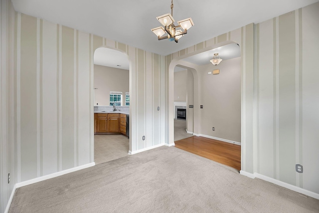 1445 Ashley Gardens Blvd, Charleston, SC 29414 - spare room with arched walkways, light colored carpet, a sink, baseboards, and wallpapered walls