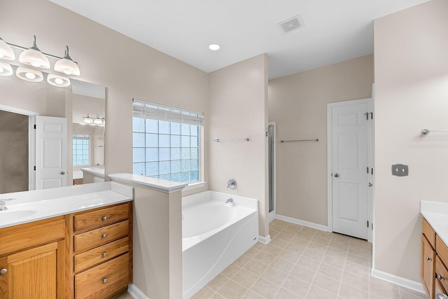 1445 Ashley Gardens Blvd, Charleston, SC 29414 - bathroom with vanity, a garden tub, baseboards, a stall shower, and tile patterned floors