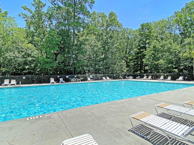 1445 Ashley Gardens Blvd, Charleston, SC 29414 - community pool featuring a patio area and view of scattered trees