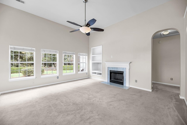 1445 Ashley Gardens Blvd, Charleston, SC 29414 - unfurnished living room featuring carpet floors, baseboards, ceiling fan, built in shelves, and high vaulted ceiling