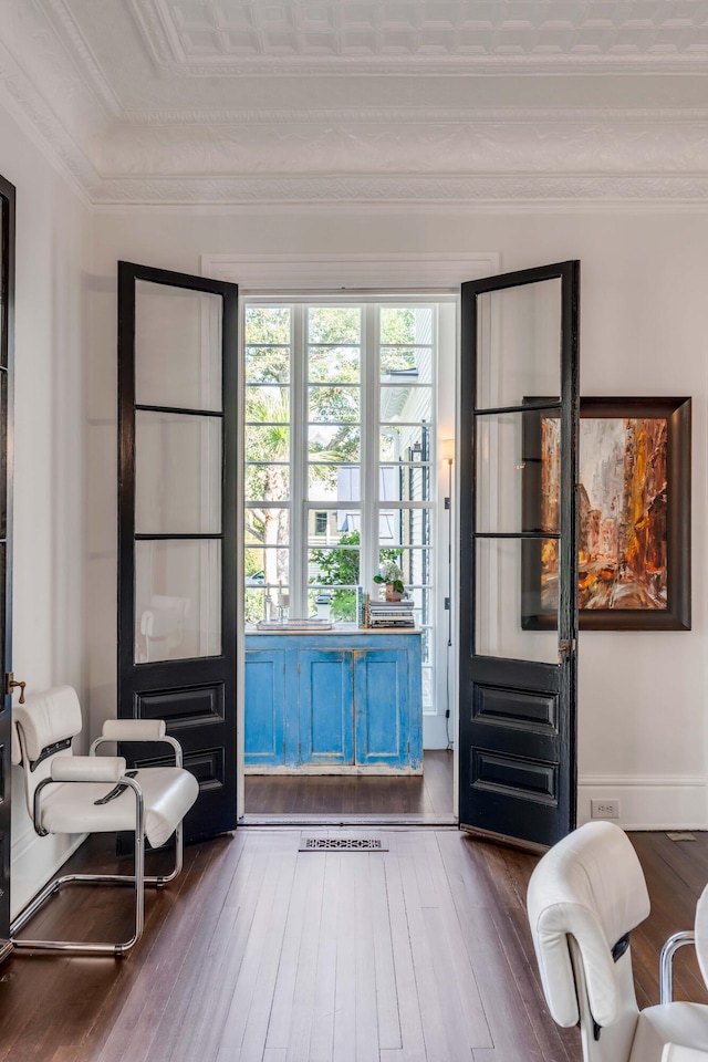 entryway featuring hardwood / wood-style flooring and crown molding