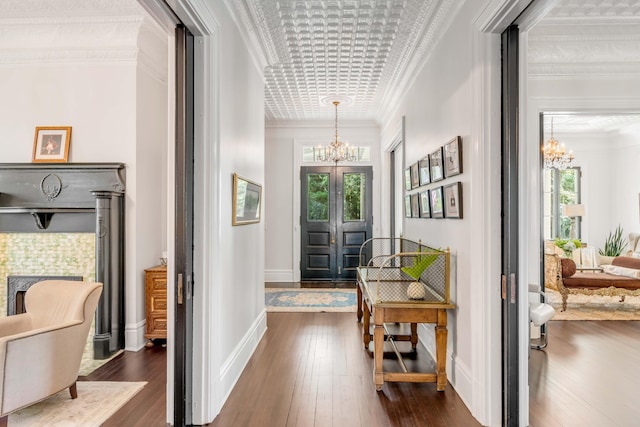 interior space featuring a healthy amount of sunlight, dark hardwood / wood-style floors, and ornamental molding